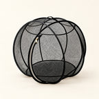 Black Foldable Cat Explorer Sphere: mesh sides, curved frame and oval zip opening on a cream background.